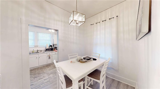 dining room with light wood-type flooring and sink