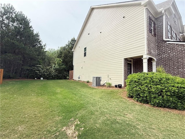 5850 Shiloh Woods Dr, Cumming, GA 30040 - view of side of property featuring brick siding, a lawn, and central AC unit