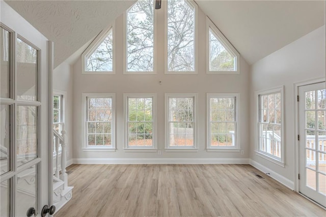 unfurnished sunroom featuring lofted ceiling