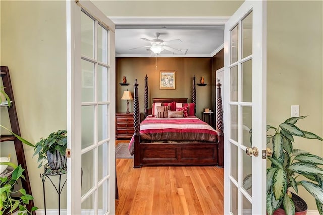 bedroom featuring french doors, wood finished floors, and crown molding