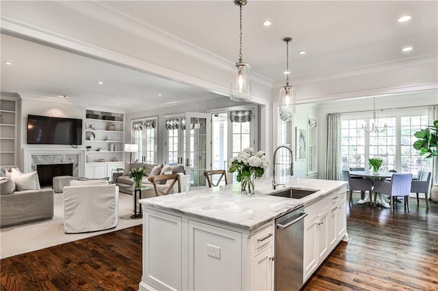 kitchen featuring white cabinetry, crown molding, dark wood finished floors, stainless steel dishwasher, and a sink