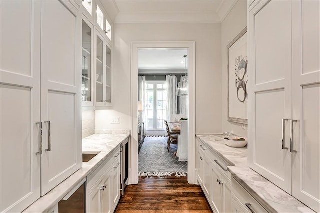 kitchen with ornamental molding, white cabinetry, dark wood-type flooring, and glass insert cabinets