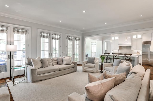 living area featuring dark wood-type flooring, french doors, recessed lighting, and ornamental molding