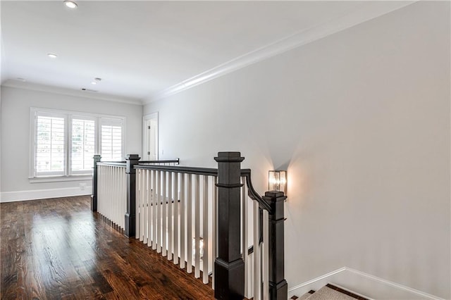 hall featuring crown molding, baseboards, dark wood finished floors, and recessed lighting