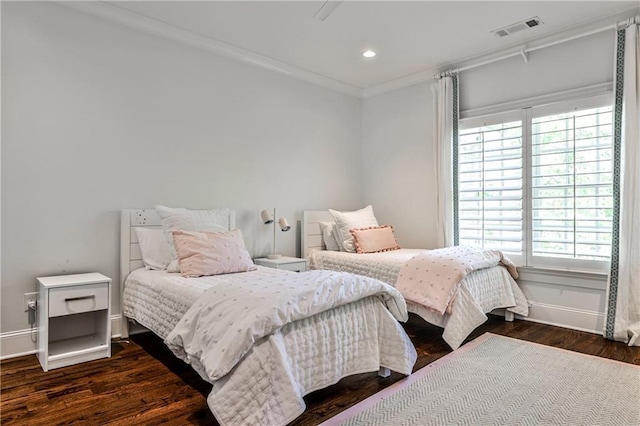 bedroom with crown molding, visible vents, multiple windows, and dark wood finished floors