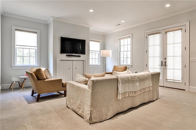 living room with light carpet, a healthy amount of sunlight, and baseboards
