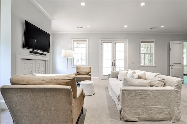 carpeted living room featuring crown molding, visible vents, recessed lighting, and french doors
