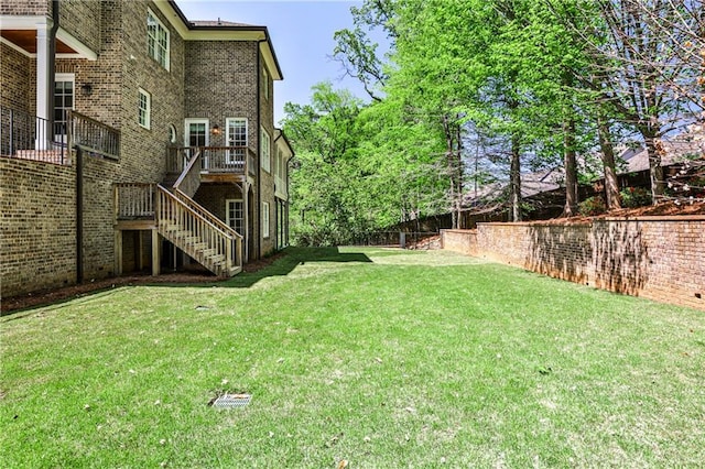 view of yard featuring stairway, a wooden deck, and fence