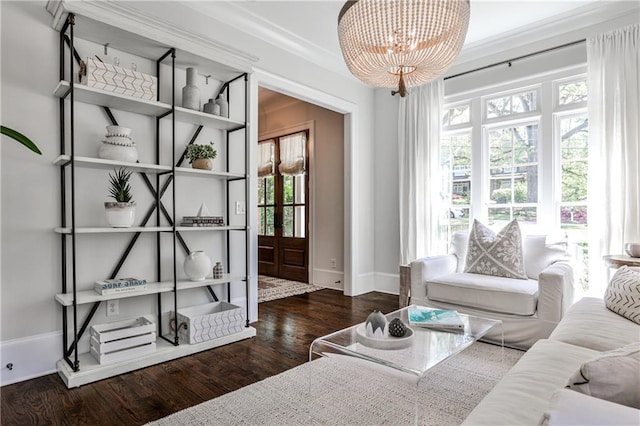 sitting room with wood finished floors, a notable chandelier, baseboards, and a wealth of natural light