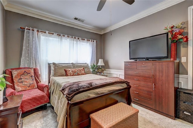 carpeted bedroom with ceiling fan and ornamental molding