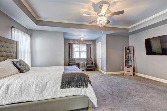 carpeted bedroom with a raised ceiling, ceiling fan, and ornamental molding