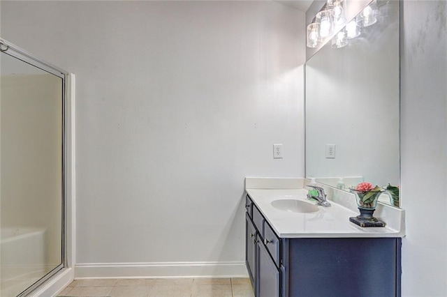 bathroom featuring tile patterned floors, vanity, and a shower with shower door