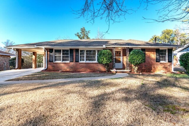 ranch-style house with a carport and a front yard