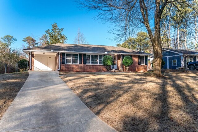 ranch-style home featuring a carport and a front yard