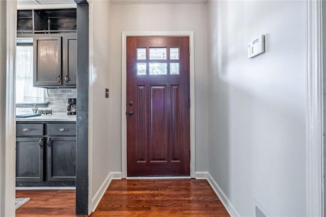 entryway with dark hardwood / wood-style flooring