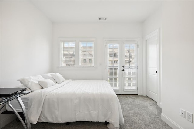 carpeted bedroom featuring access to exterior and french doors