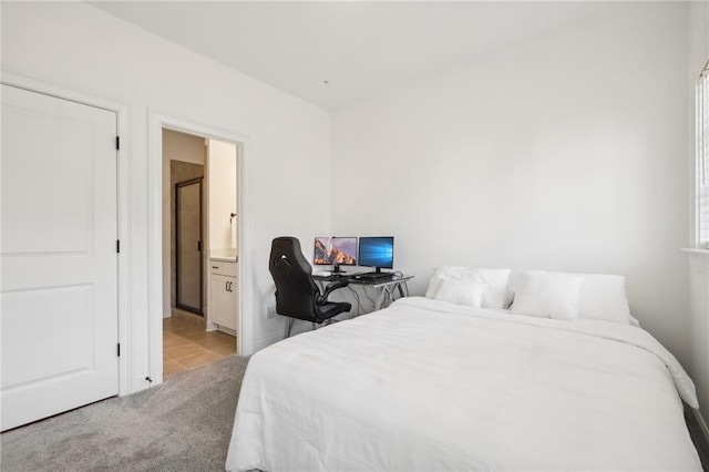 carpeted bedroom featuring ensuite bath