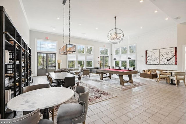 playroom featuring french doors, pool table, light tile patterned floors, ornamental molding, and a high ceiling