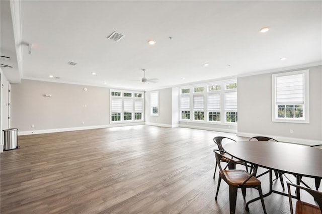 living room featuring hardwood / wood-style flooring, ceiling fan, and ornamental molding