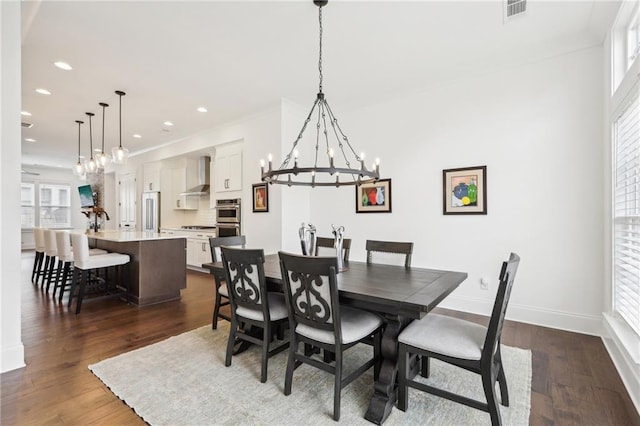 dining room featuring an inviting chandelier and dark hardwood / wood-style flooring