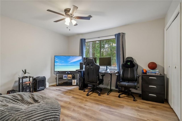 home office featuring light wood-style flooring, baseboards, and ceiling fan