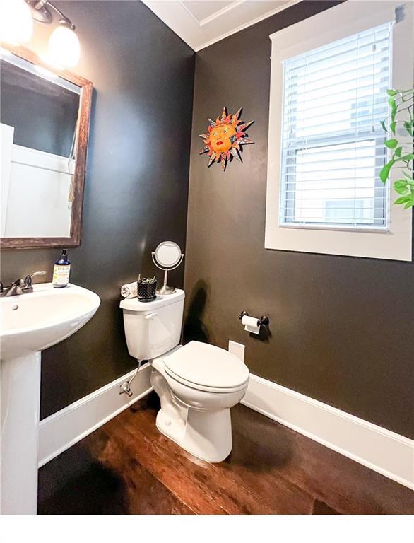 bathroom featuring hardwood / wood-style flooring, sink, and toilet