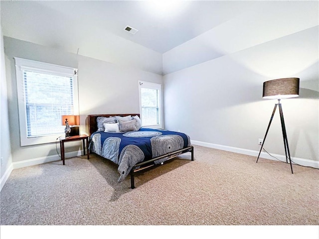 carpeted bedroom featuring vaulted ceiling