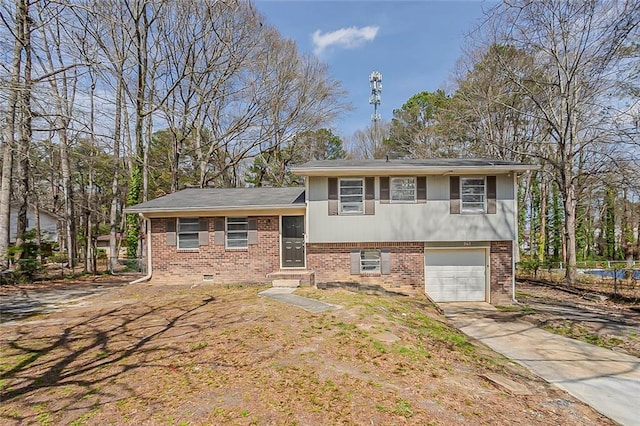 tri-level home featuring brick siding, driveway, and a garage