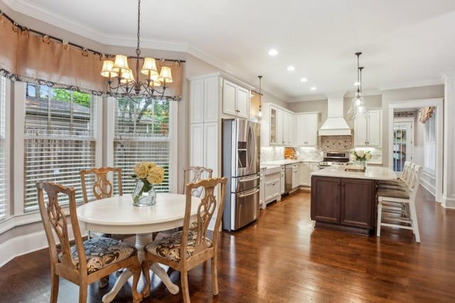 dining space featuring dark wood-type flooring, crown molding, a chandelier, and recessed lighting