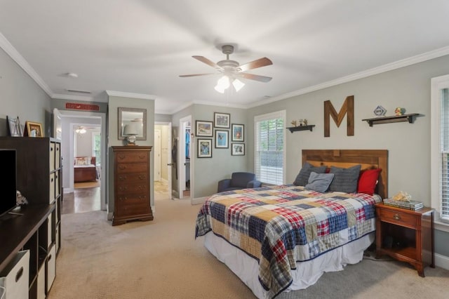 bedroom with light colored carpet, ornamental molding, baseboards, and a ceiling fan