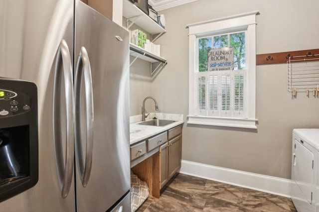 laundry room featuring washing machine and dryer and baseboards