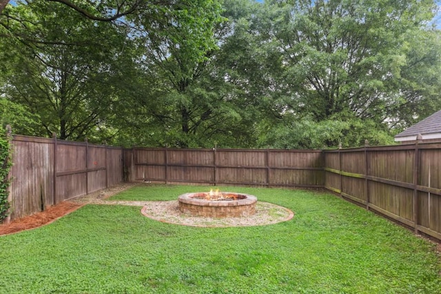view of yard with a fire pit