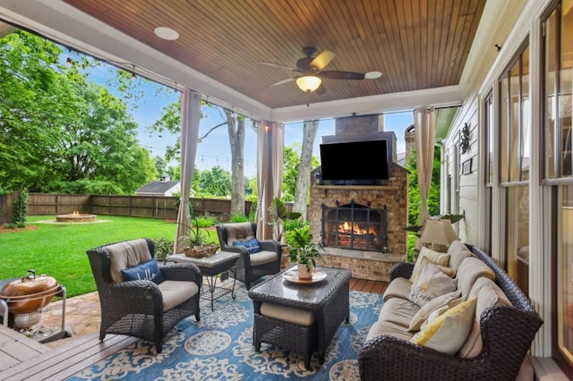 view of patio / terrace featuring an outdoor living space with a fireplace and ceiling fan
