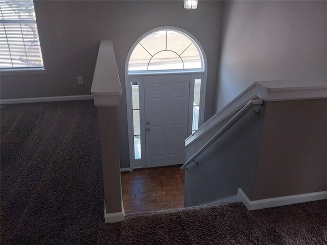 foyer entrance featuring dark parquet flooring