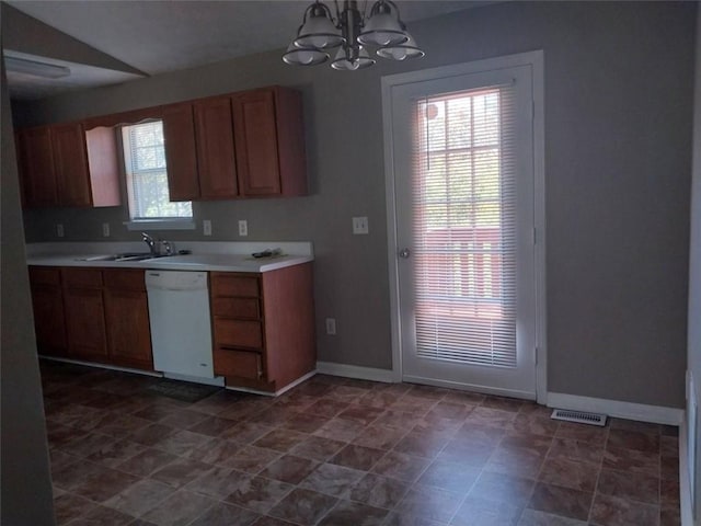 kitchen with white dishwasher, hanging light fixtures, a notable chandelier, and sink