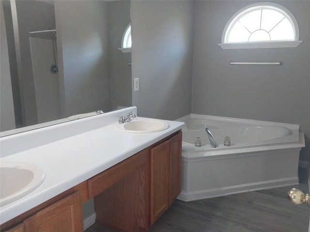 bathroom featuring hardwood / wood-style floors, vanity, and independent shower and bath