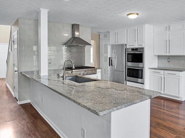 3725 Crescent Walk Ln, Suwanee, GA 30024 - kitchen with wall chimney range hood, appliances with stainless steel finishes, light stone countertops, tasteful backsplash, and white cabinets