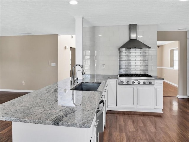 3725 Crescent Walk Ln, Suwanee, GA 30024 - kitchen featuring wall chimney exhaust hood, stainless steel gas cooktop, light stone counters, dark wood-type flooring, and white cabinets