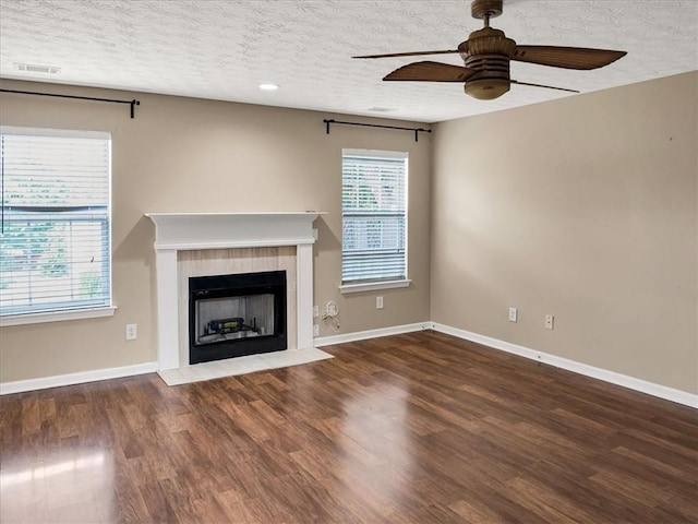 3725 Crescent Walk Ln, Suwanee, GA 30024 - unfurnished living room with a ceiling fan, a textured ceiling, a fireplace with flush hearth, and wood finished floors