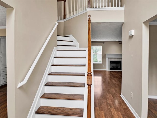 3725 Crescent Walk Ln, Suwanee, GA 30024 - stairs featuring wood finished floors and a fireplace with flush hearth