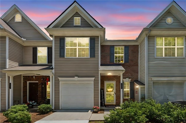 299 Azalea Cir, Cumming, GA 30040 - view of front of home with an attached garage, driveway, and brick siding