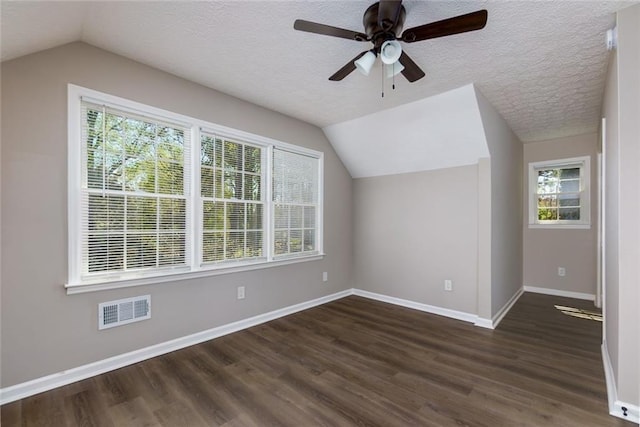 216 Hickory Way, Canton, GA 30115 - additional living space with dark wood finished floors, vaulted ceiling, ceiling fan, and a textured ceiling