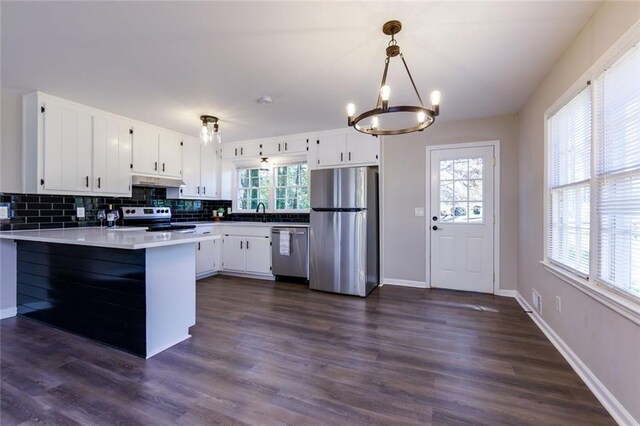 216 Hickory Way, Canton, GA 30115 - kitchen featuring appliances with stainless steel finishes, a chandelier, a peninsula, backsplash, and under cabinet range hood