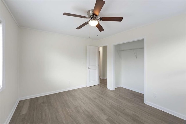 unfurnished bedroom with ceiling fan, a closet, baseboards, and wood finished floors