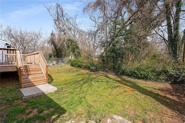 view of yard featuring a deck and fence