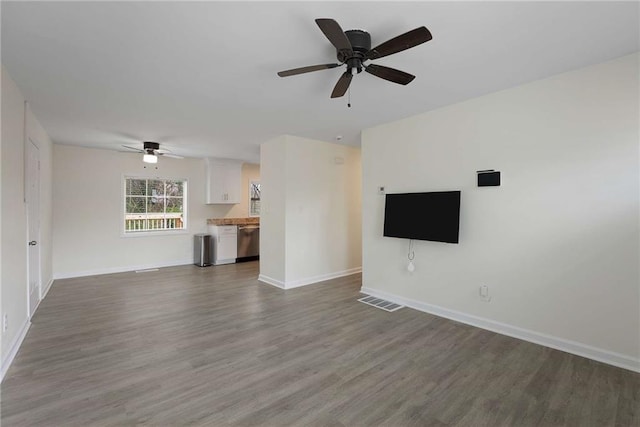 unfurnished living room featuring visible vents, ceiling fan, baseboards, and wood finished floors