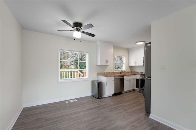 kitchen with white cabinets, baseboards, visible vents, and appliances with stainless steel finishes