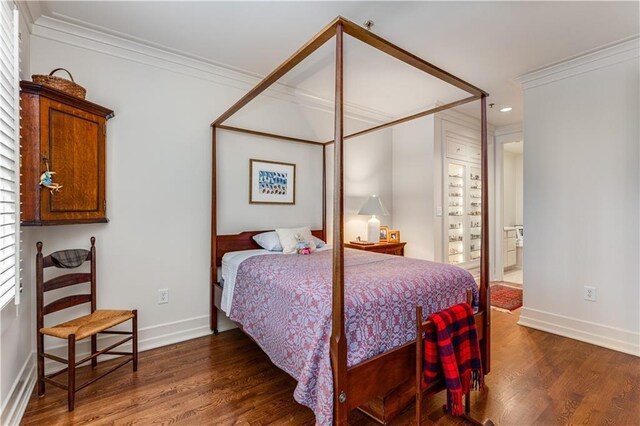 bedroom with ornamental molding, recessed lighting, wood finished floors, and baseboards