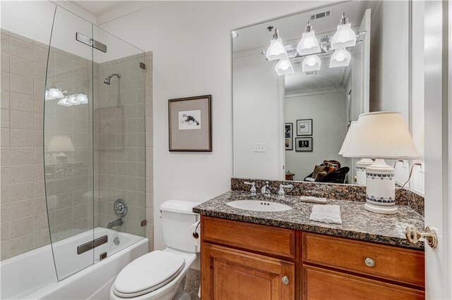 full bath with toilet, ornamental molding, shower / bath combination with glass door, and vanity