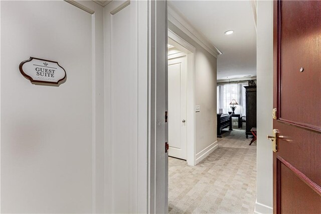 hallway with baseboards, light floors, and recessed lighting